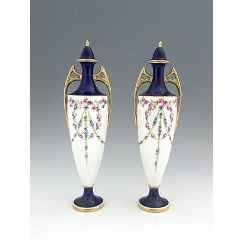 898 - A pair of Minton vases and covers, pedestal twin handled urn form, painted with garlands of roses, p... 