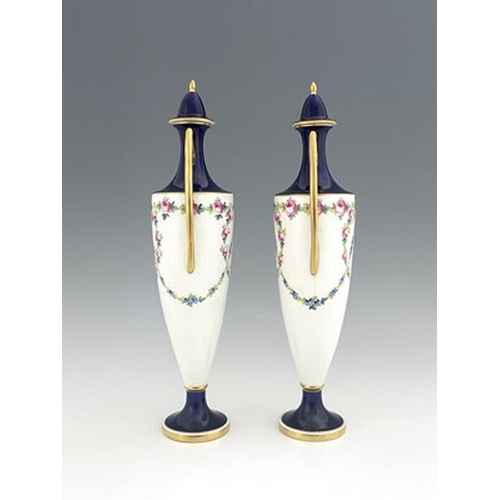 898 - A pair of Minton vases and covers, pedestal twin handled urn form, painted with garlands of roses, p... 