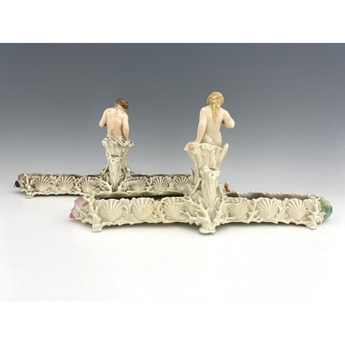 904 - A pair of Royal Worcester pearlescent lure figural centrepiece vases, each with a nymph type figure ... 