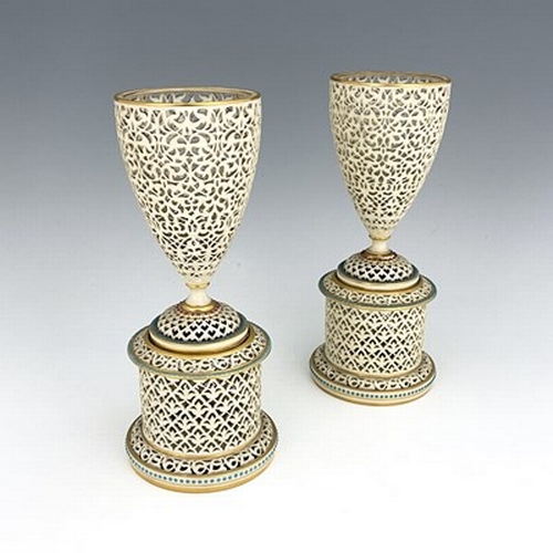 905 - A pair of Worcester Royal China Works reticulated pedestal vases, urn form on drum bases, pierced wi... 