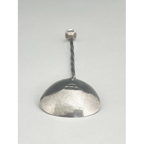 92 - A E Jones, an Arts and Crafts silver spoon, Birmingham 1907, triangular planished bowl on a square s... 