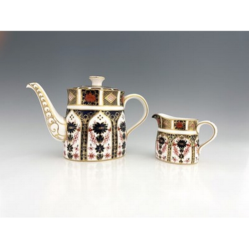 925 - A Royal Crown Derby Imari 1128 teapot and jug, 1968, oval section ogee form, 28cm long (2)