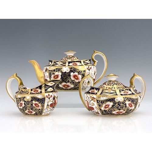 928 - A Royal Crown Derby Imari 2451 pattern three piece tea set, 1898, of boat or helmet form, including ... 