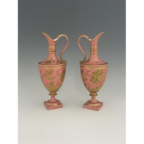 931 - A pair of Royal Crown Derby pink ground and gilt Derby Ewers, 1886, painted in the Aesthetic style w... 