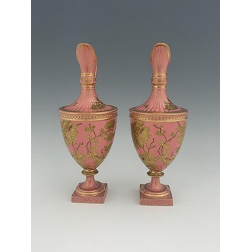 931 - A pair of Royal Crown Derby pink ground and gilt Derby Ewers, 1886, painted in the Aesthetic style w... 