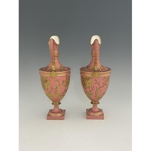 931 - A pair of Royal Crown Derby pink ground and gilt Derby Ewers, 1886, painted in the Aesthetic style w... 