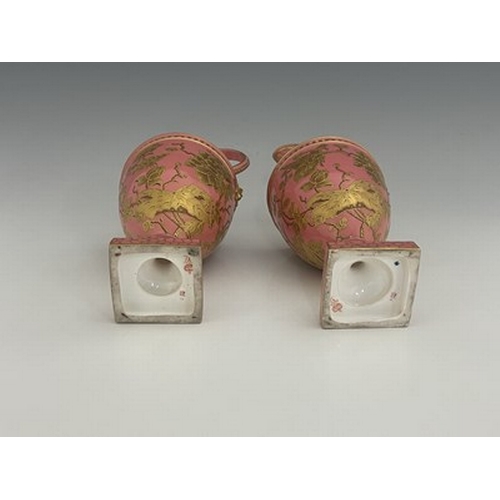 931 - A pair of Royal Crown Derby pink ground and gilt Derby Ewers, 1886, painted in the Aesthetic style w... 