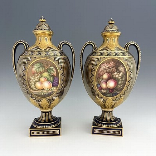 932 - James Rouse Senior for Royal Crown Derby, a pair of twin handled floral and fruit painted vases and ... 