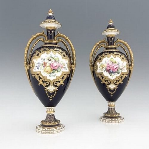 939 - Cuthbert Gresley for Royal Crown Derby, a pair of floral painted twin handled vases and covers, 1907... 