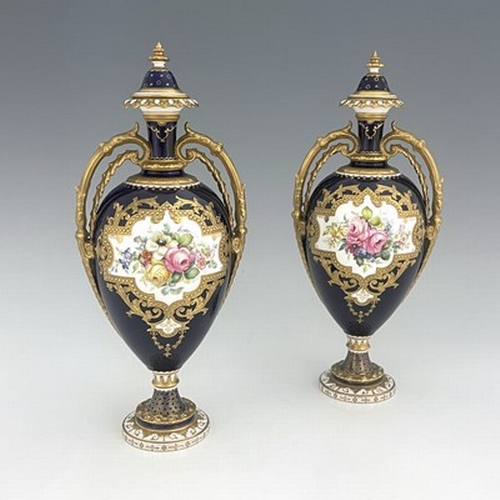 939 - Cuthbert Gresley for Royal Crown Derby, a pair of floral painted twin handled vases and covers, 1907... 