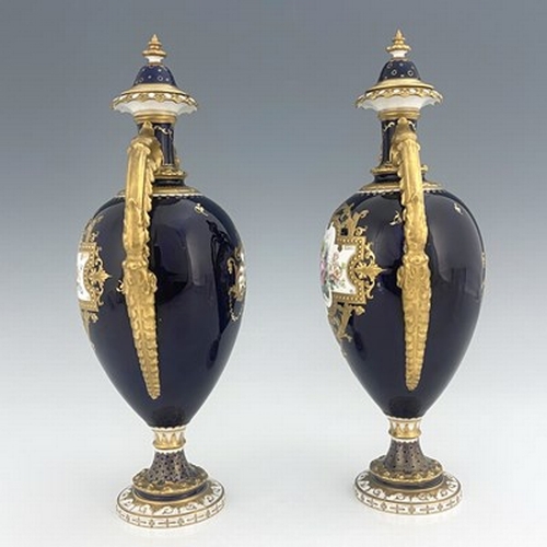 939 - Cuthbert Gresley for Royal Crown Derby, a pair of floral painted twin handled vases and covers, 1907... 