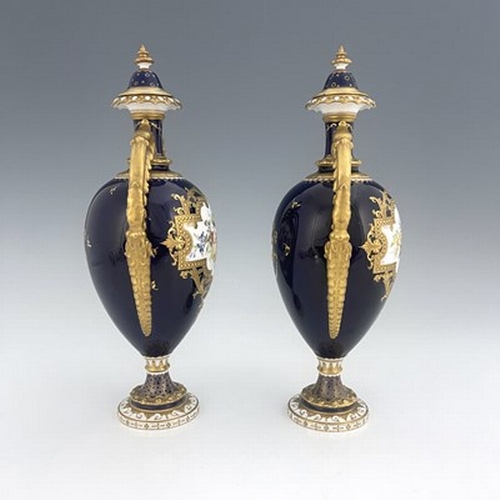 939 - Cuthbert Gresley for Royal Crown Derby, a pair of floral painted twin handled vases and covers, 1907... 