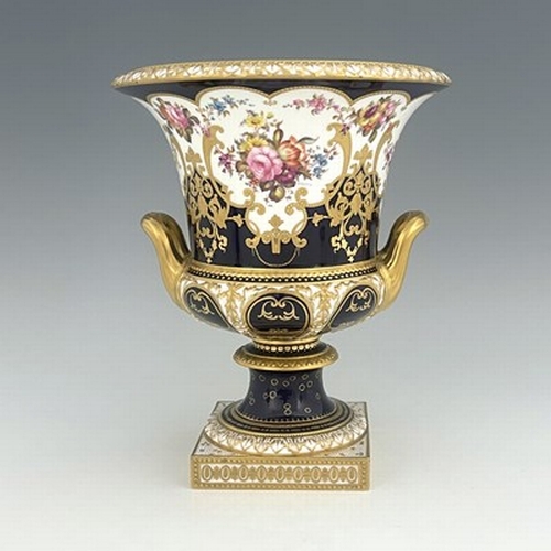 940 - W Mosley for Royal Crown Derby, a floral painted twin handled Campana Urn, 1903, decorated with a co... 