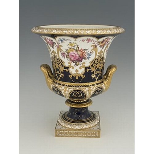 940 - W Mosley for Royal Crown Derby, a floral painted twin handled Campana Urn, 1903, decorated with a co... 