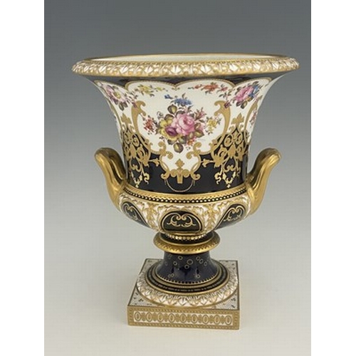 940 - W Mosley for Royal Crown Derby, a floral painted twin handled Campana Urn, 1903, decorated with a co... 