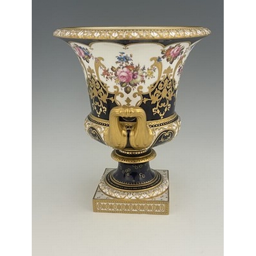 940 - W Mosley for Royal Crown Derby, a floral painted twin handled Campana Urn, 1903, decorated with a co... 