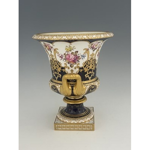 940 - W Mosley for Royal Crown Derby, a floral painted twin handled Campana Urn, 1903, decorated with a co... 