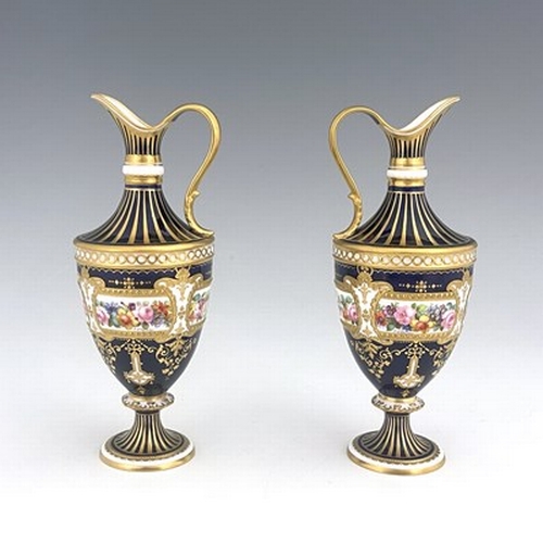 942 - Albert Gregory for Royal Crown Derby, a pair of floral painted ewers, shouldered urn form, decorated... 