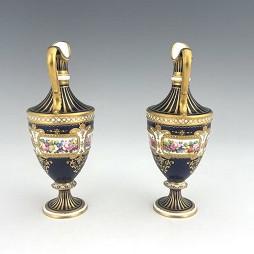 942 - Albert Gregory for Royal Crown Derby, a pair of floral painted ewers, shouldered urn form, decorated... 