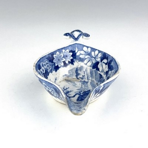 959 - A pearlware blue and white pap boat, circa 1800, relief moulded shell handle, decorated with gardene... 