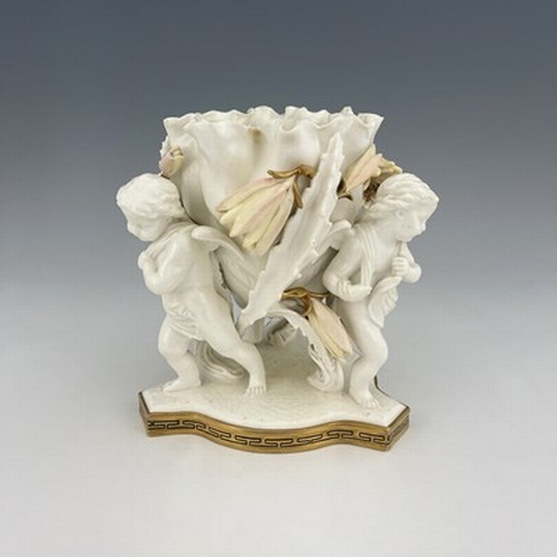 961 - Moore and Co., a blanc de Chine figural bowl, circa 1860, modelled as three winged putti supporting ... 