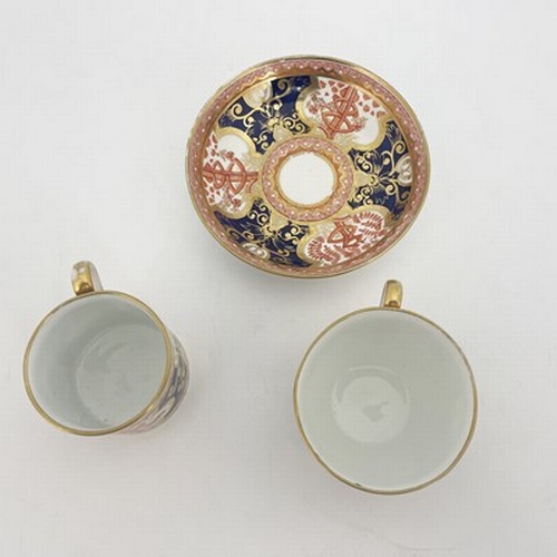 969 - A Spode trio, two cups and saucer, circa 1810, painted in Dollar pattern of iron red, blue and gilt,... 