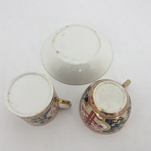 969 - A Spode trio, two cups and saucer, circa 1810, painted in Dollar pattern of iron red, blue and gilt,... 