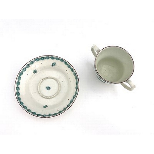 974 - A Bristol porcelain trembleuse chocolate cup and saucer, circa 1760, the twin handled ogee cup paint... 