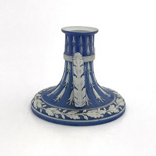 988 - A Wedgwood blue Jasperware chamber stick, circa 1790, fluted trumpet form, with husk garlands and oa... 