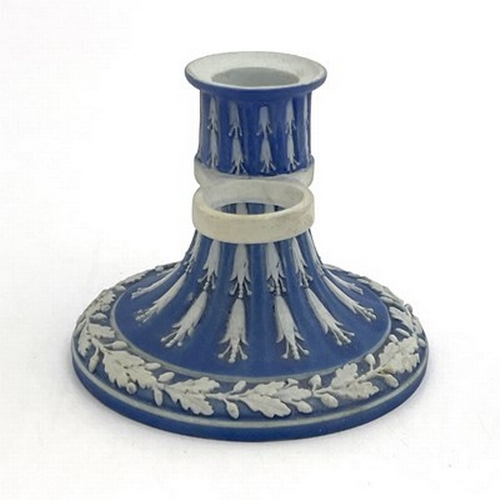 988 - A Wedgwood blue Jasperware chamber stick, circa 1790, fluted trumpet form, with husk garlands and oa... 