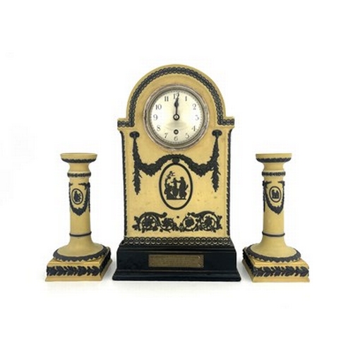 988A - A Wedgwood tri colour Jasperware clock garniture set, yellow ground, domed bracket form with black r... 