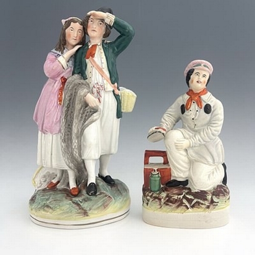 127 - A Staffordshire figure group, late nineteenth-century, 'Fisherman and Companion' figure modelled as ... 