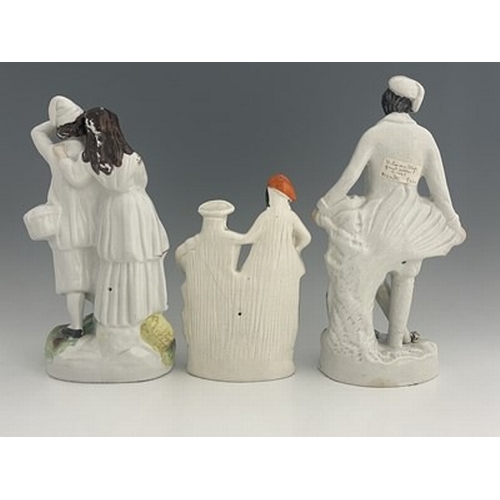 128 - Three Staffordshire figure groups , circa 1865, one modelled as a standing male fruit seller in whit... 