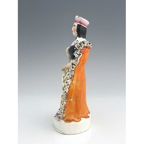 131 - A Staffordshire figure of Sarah Siddons as Lady Macbeth, circa 1850, modelled as a Queen in textured... 