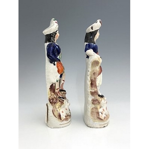 132 - A pair of Staffordshire shepherd and shepherdess figures in Scottish Highland dress, circa 1850, Sco... 