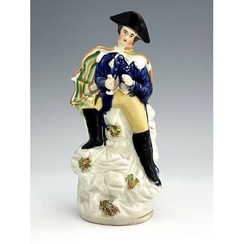 142 - A Staffordshire portrait figure of Napoleon, circa 1840, modelled in military uniform and bicorn hat... 