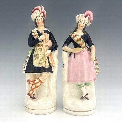 145 - Staffordshire figure pair of Scottish musicians and dancers, circa 1850, modelled as a standing male... 