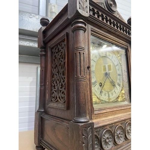 180 - A German carved oak Aesthetic Movement mantel clock, architectural case, with silvered chapter ring ... 