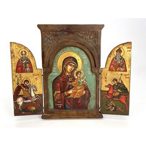 196 - A Greek Orthodox triptych ikon, wooden frame with leaf-carved spandrels to the pediment, hinged doub... 