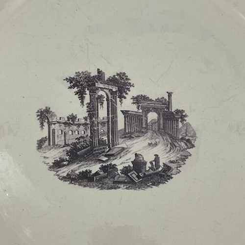 197 - A large English creamware charger, 18th century, decorated with an image of Palmyra. 39 cm diameter.