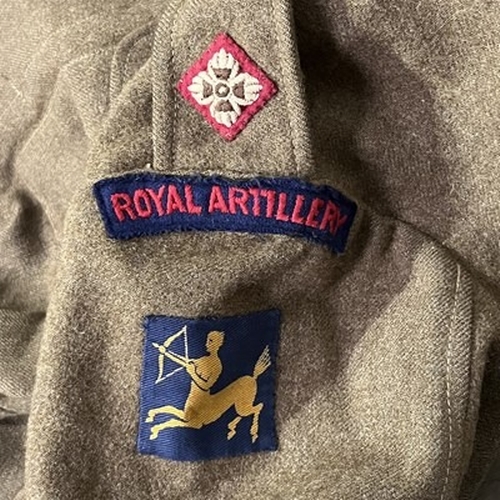 1A - A collection of Military apparel, to include two Royal Artillery battle dress jackets, two Royal Art... 