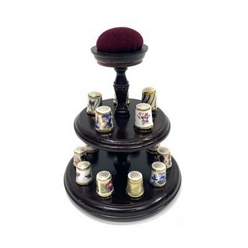 233 - A collection of fifteen Royal Crown Derby thimbles on two tier turned wooden stand with pin cushion ... 