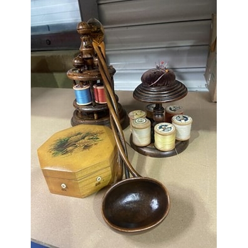 281 - Two treen bobbin holders, a Mauchline ware ladle, a Mauchline ware reel box with all thread guides i... 