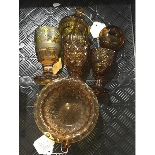 8 - A collection of Bohemian amber glassware, including two sweetmeat jars and covers, a goblet with etc... 