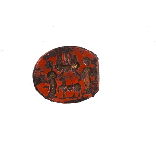 258 - A Roman intaglio, carved with two figures flanking a goat type animal, red hardstone, 1.5cm long