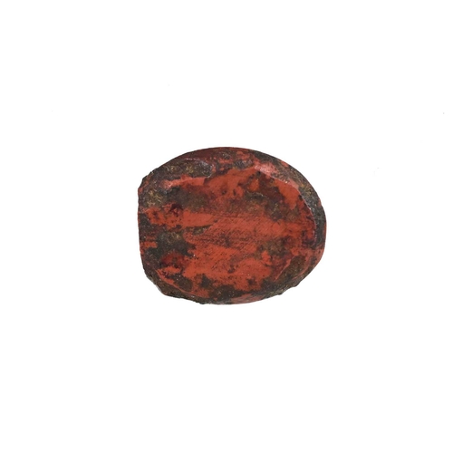 258 - A Roman intaglio, carved with two figures flanking a goat type animal, red hardstone, 1.5cm long