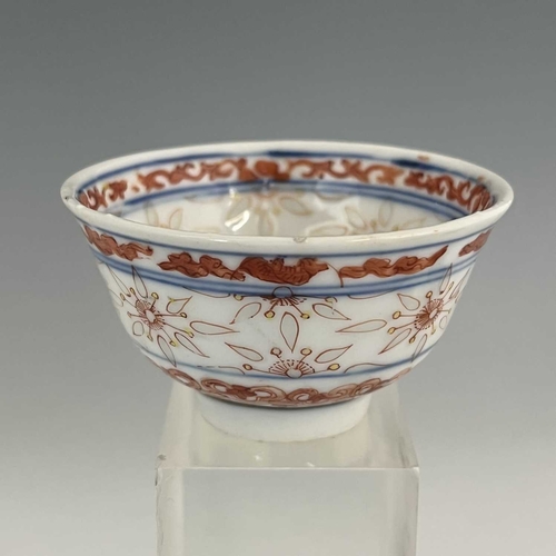 347a - A Chinese porcelain rice grain tea bowl, decorated in iron red with auspicious motifs and translucen... 