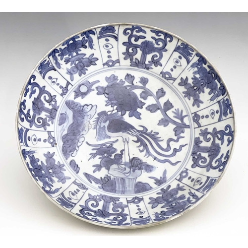 348 - A Chinese blue and white dish, Ming, painted with a bird on rock with peony design, within a pannell... 