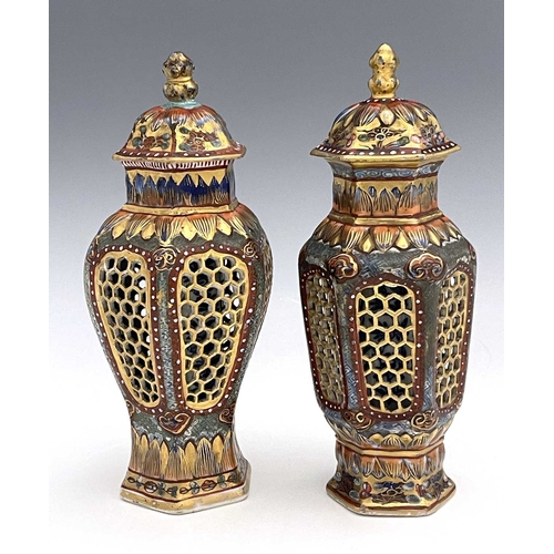 353 - A matched pair of Chinese reticulated vases and covers, hexagonal section inverse baluster form, wit... 