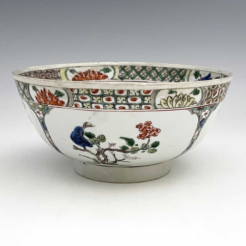 354 - A Chinese famille verte bowl, painted with panels of prunus and chrysanthemums, the trellis border p... 